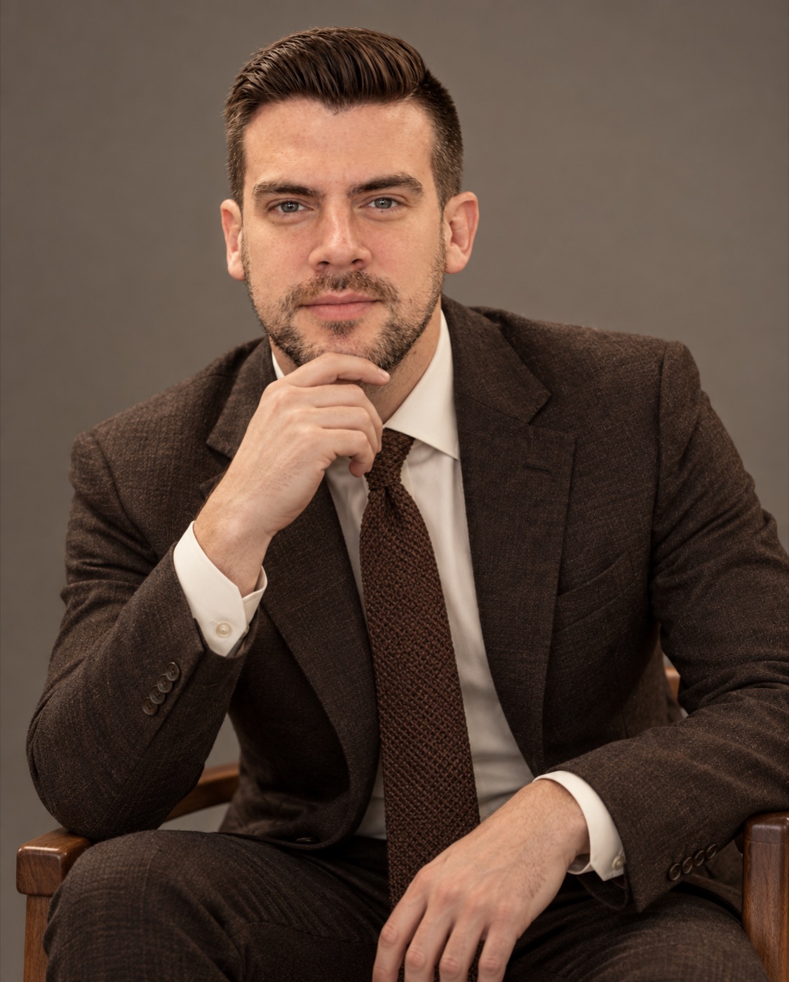 Vayden Foster seated, hand at chin